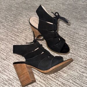 Date night approved. Black suede cutout block heels with lace up detail